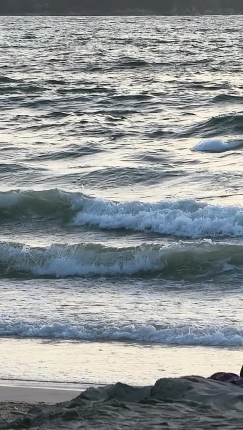 Ocean Waves Rolling onto Sandy Beach Coast During Evening Light Stock Footage 341007611