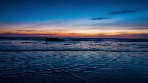 Ocean waves rolling on sandy beach shore at colorful sunset Stock Footage 342396093