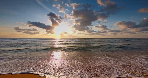 Ocean waves rolling on the sea sand toward sandy beach at sunrise Stock Footage 344739794