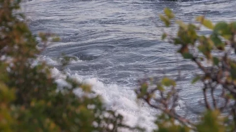Ocean Waves Rolling Toward a Rocky Coastline. Powerful Sea Waves Breaking Near a Stock Footage 336916900
