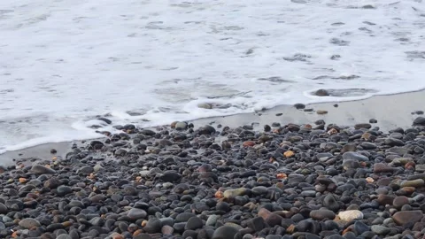 Ocean waves rolling toward a wet pebble beach Stock Footage 341917051