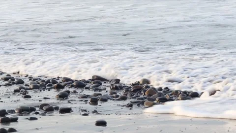 Ocean waves rolling toward a wet pebble beach Stock Footage 341917090