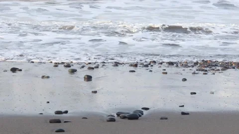 Ocean waves rolling toward a wet pebble beach Stock Footage 341917160