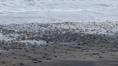 Ocean waves rolling toward a wet pebble beach Stock Footage 341917167