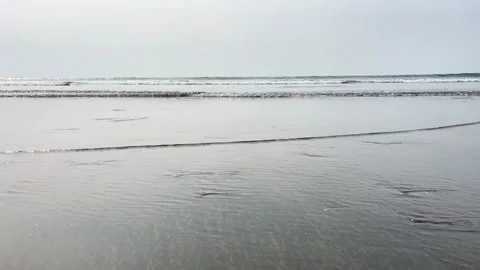Ocean Waves Rolling Under Cloudy Sky  Dramatic Coastal Weather Scene Stock-Footage 311695230