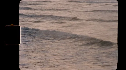 Ocean waves rolling on the water surface in vintage Super 8 film style Stock Footage 345489760