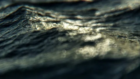 Ocean waves of a rough agitated sea in seamless loop normal motion, macro bokeh Stock Footage