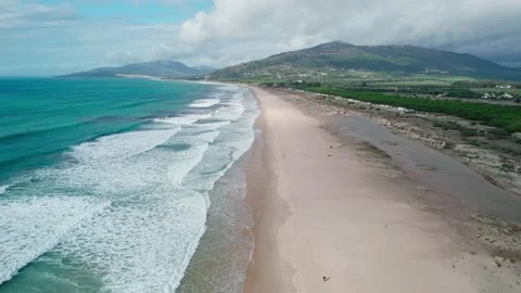 Ocean waves run over the beach view from a drone Stock Footage 230241623