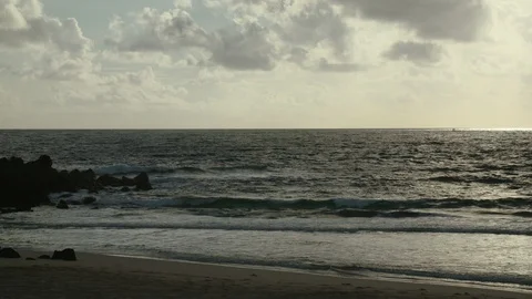 Ocean waves rushing towards beach on a sunny day Stock Footage 117739653