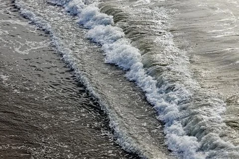 Ocean waves on the sand. 스톡 사진