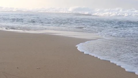 Ocean waves on sandy beach at sunrise. Stock Footage 320441994