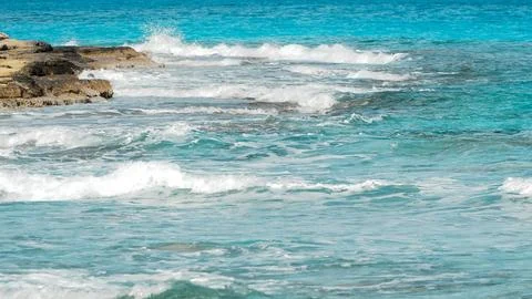 Ocean waves on a sandy beach under a blue summer sky on matrouh Stock Photos