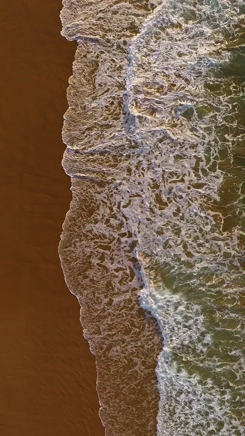 Ocean waves sandy shoreline aerial top view. Waves caress ocean edge, beauty Video stock 318601672