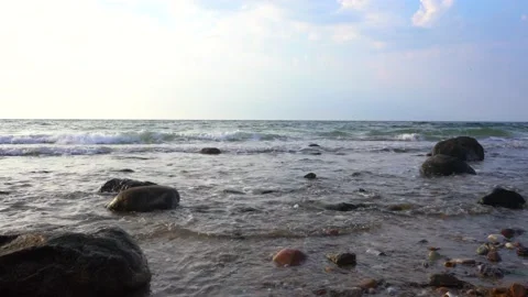 Ocean waves by Scandinavian beach at sunset Stock Footage 205869701