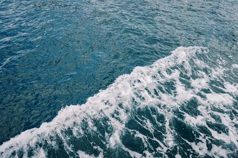 Ocean waves sparkle. Dynamic blue waters showcasing foamy waves and luminous Stock Photos