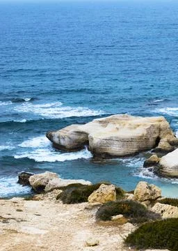 Ocean waves splash against beach with rocks background, Cliffs in the sea Stock Photos