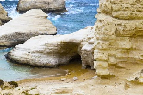 Ocean waves splash against beach with rocks background, Cliffs in the sea Stock Photos