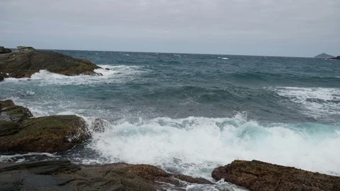 Ocean Waves splash against rocks in the coast of Buzios, Brazil Stock Footage 92075631
