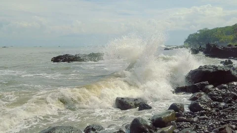 Ocean Waves Splashing and Foaming After Crashing Into Big Hard Rock on Seashore. Stock-Footage 107479724