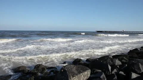 Ocean waves splashing on black rocks in Bay of Bengal Ocean in Pondicherry Stock Footage 61210782