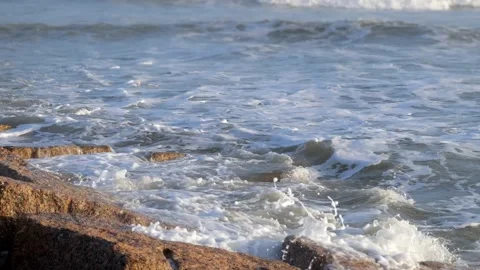 Ocean waves splashing onto large granite rocks. Stock Footage 238932153