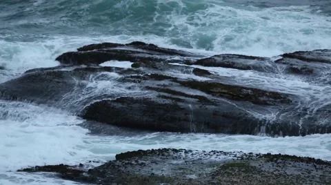 Ocean waves splashing over rocks Stock Footage 52358684