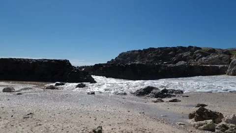 Ocean waves splashing over rocks in a rocky cove Stock Footage 337883008