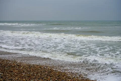 Ocean waves on a stone pebble beach Stock Photos