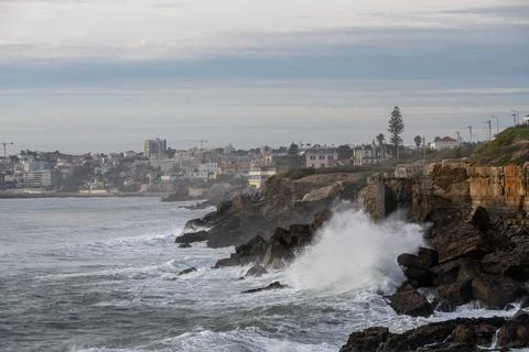 Ocean waves striking cliffs below Estoril town Stock Photos