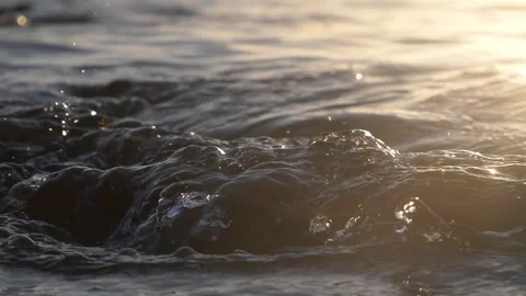 Ocean Waves At Sunset Close-Up With Golden Hour Ripples, Foam And Sea Surface Stock Footage 337307527