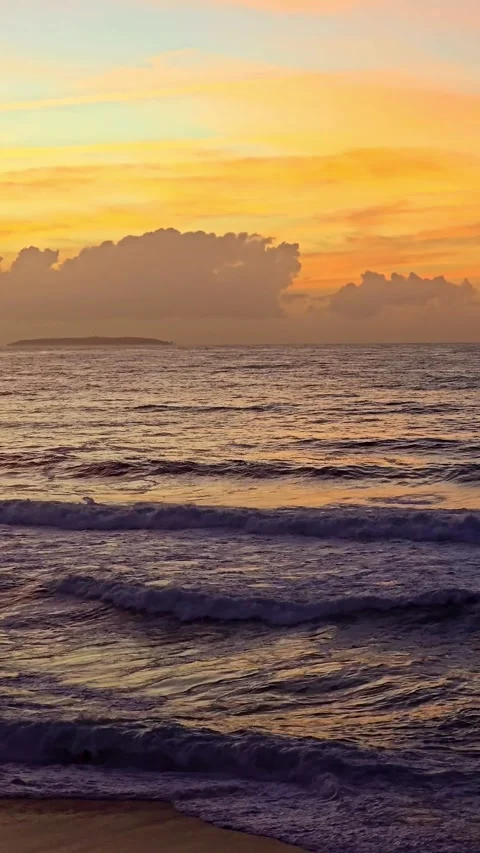Ocean waves at sunset with clouds on the horizon Stock Footage 346810349