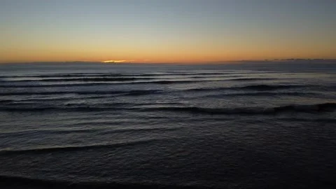 Ocean waves with sunset on the horizon 4K Stock Footage 154580522