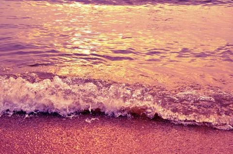 The ocean waves in sunset light Stock Photos
