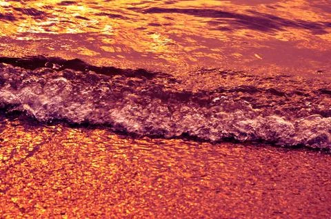 The ocean waves in sunset light Stock Photos
