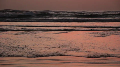 Ocean waves at sunset. Reddish reflections. Nature Background. Stock Footage 285151377