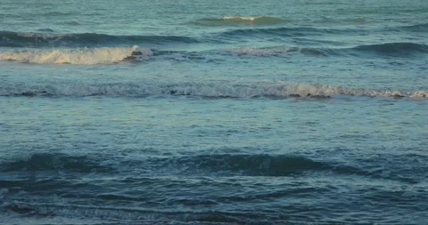 Ocean waves at sunset, tranquil sea landscape with gentle surf and Stock Footage 303816706