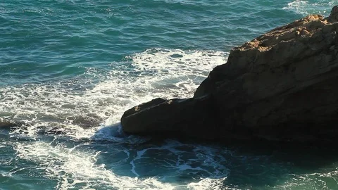 Ocean Waves Surge Over Rocky Headland, blue sea breaking on rocks Stock Footage 101882591