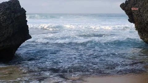 Ocean Waves Through Rocks with Beach Landscape. Stock Footage 320441996
