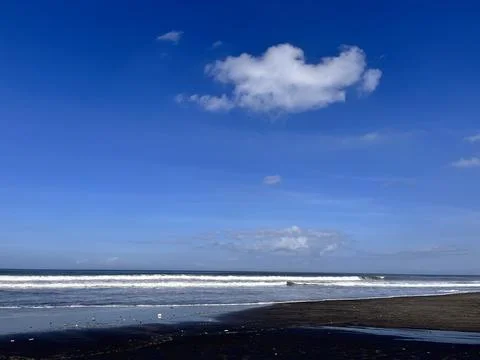 Ocean Waves on Tropical Beach Under Blue Sky Stock Photos