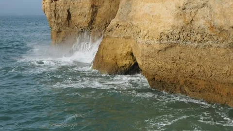 Ocean waves violently collide with rugged cliffs. Vídeos de archivo 258969326