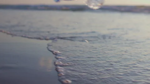 Ocean waves wash away a plastic bottle thrown into the sea. Environmental issue Stock Footage 318215584
