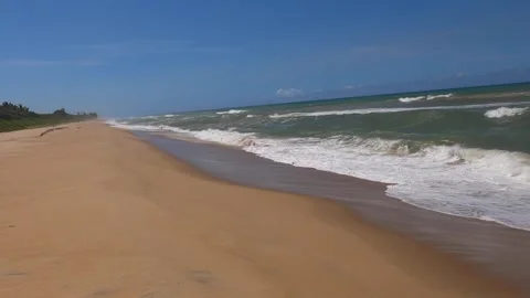 Ocean waves wash over sand beach along the eastern shore of Madagascar Stock Footage 310534441