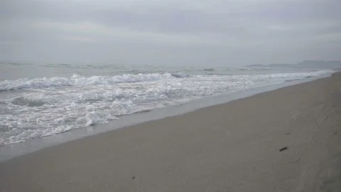 Ocean waves wash the sandy beach shore Stock Footage 91347548