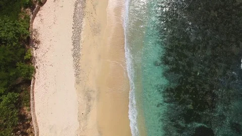 Ocean waves wash the shore of deserted beach Stock Footage 111777053