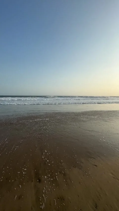 Ocean Waves Washing Ashore on Sandy Beach, Golden Hour, Vertical Tracking Shot Stock Footage 324772252