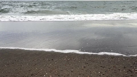 Ocean waves washing up on a dark sand beach time lapse Stock Footage 341118841