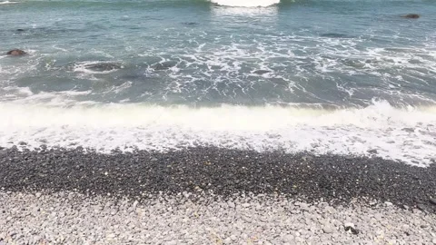 Ocean waves washing over a pebble beach Stock Footage 342044730