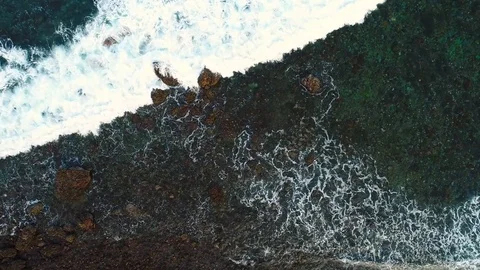 Ocean waves washing up on rock Stock Footage 83909578