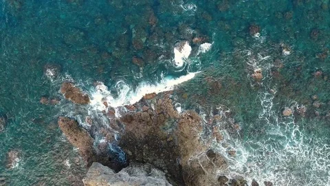 Ocean waves washing up on rock Stock Footage 83909621