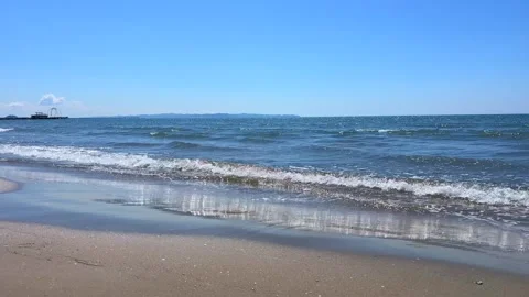 Ocean Waves Washing Onto Sandy Beach With Distant Pier View Stock Footage 310232824